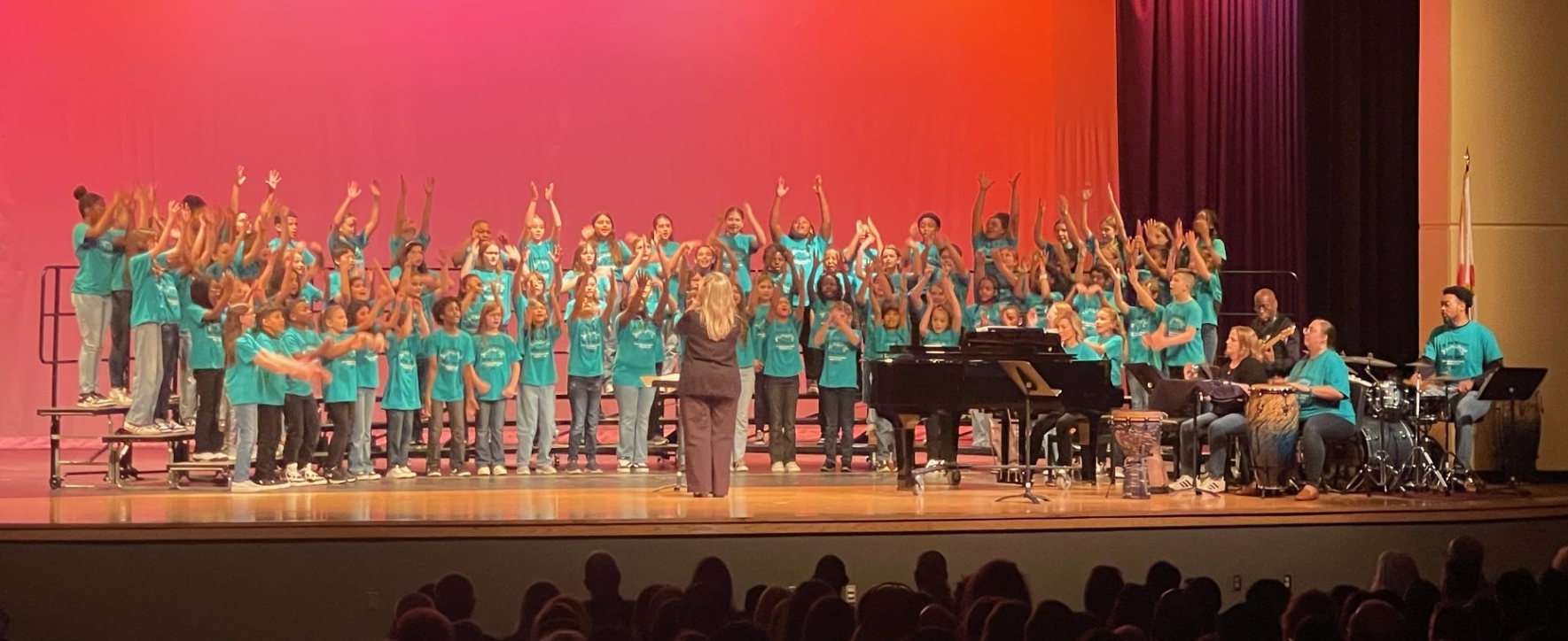 Elementary Honor Choir Students singing on stage