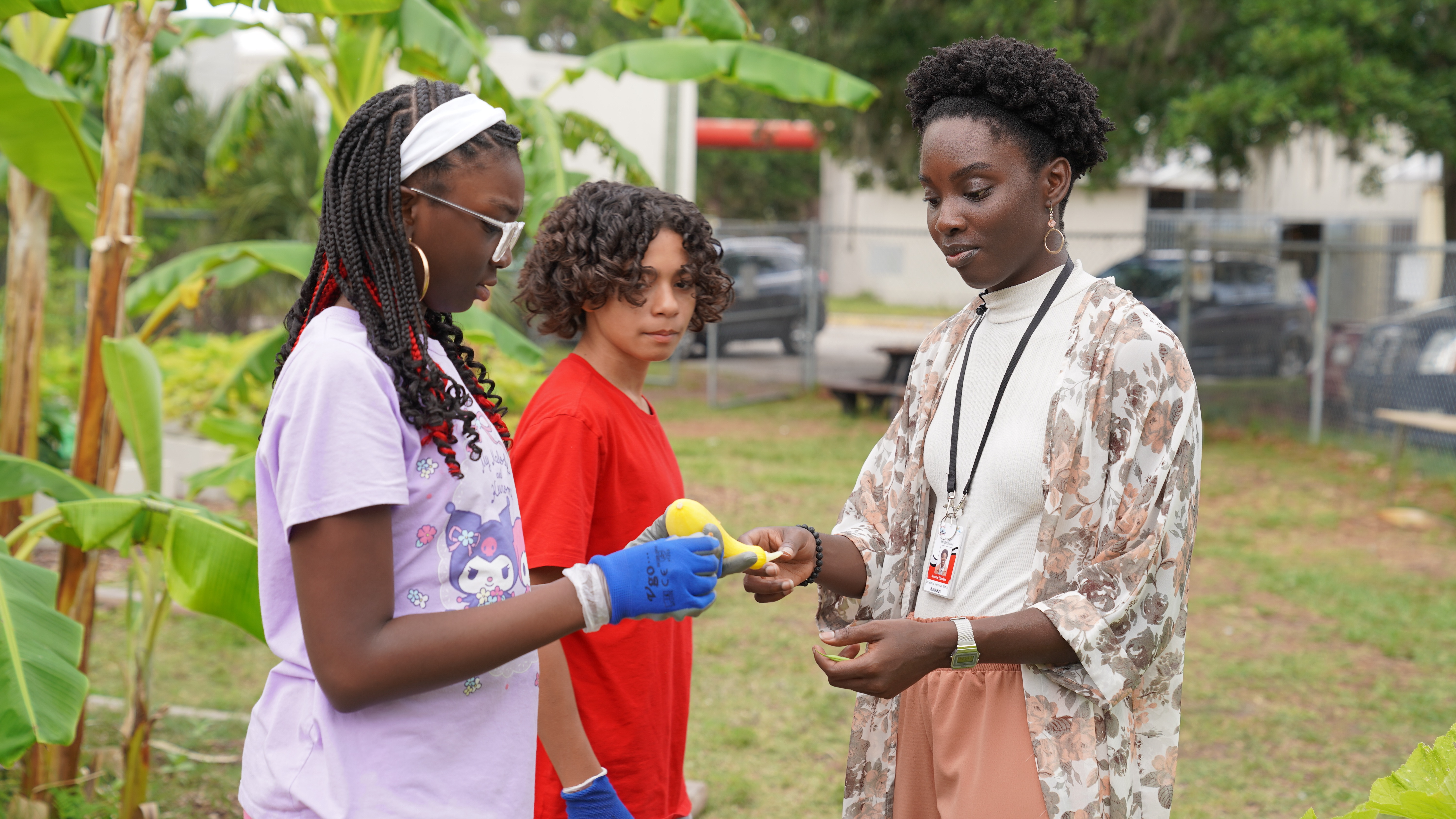 Amaris Daniels works with students in the school garden at Mayport Coastal Sciences Middle School, teaching hands-on lessons about growth and responsibility.