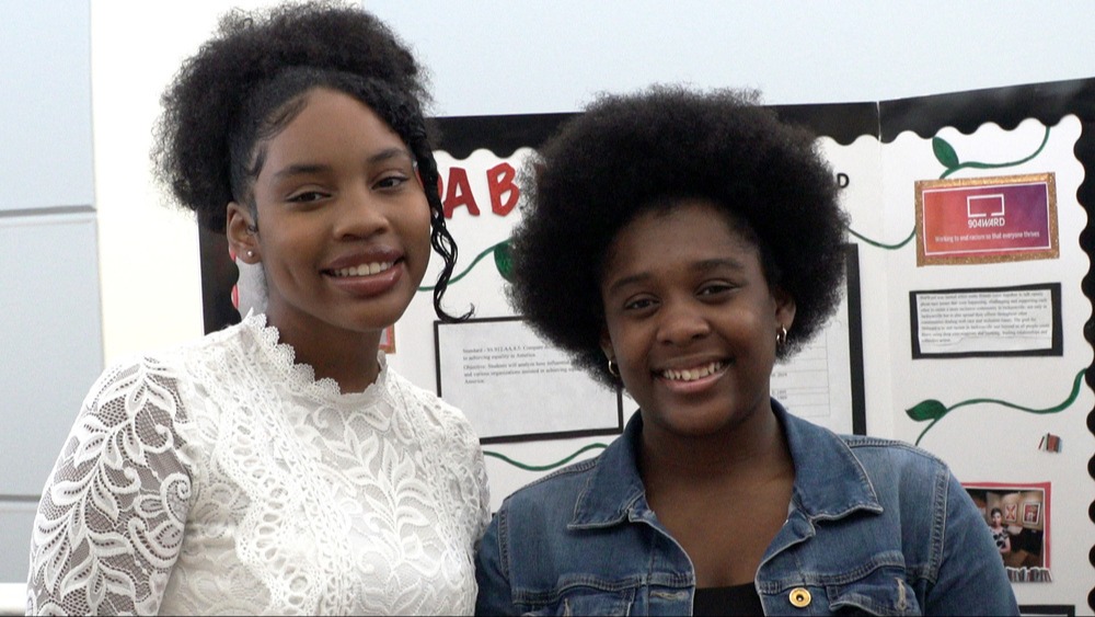 Two smiling students participating in the African American Summer Writing Institute