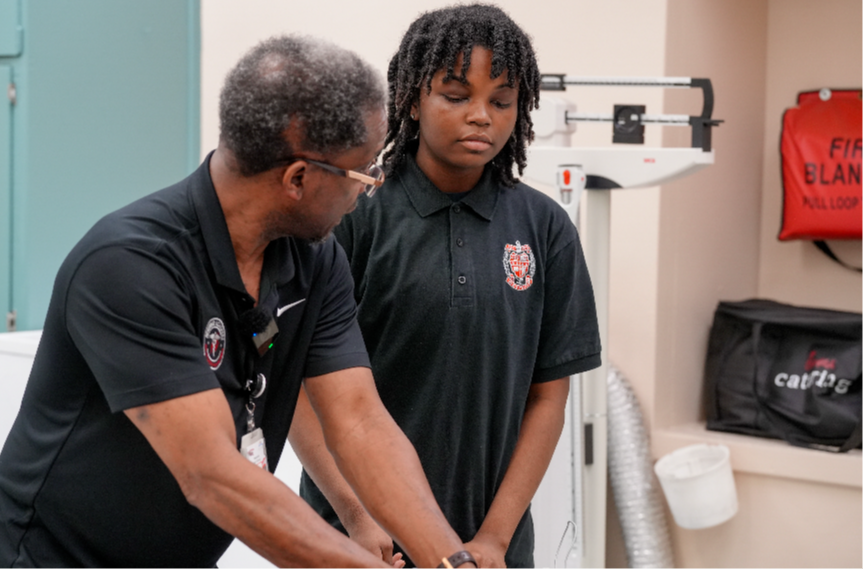 Christopher McNealy, a health science teacher at Westside High School, leads students during a hands-on health care lesson.
