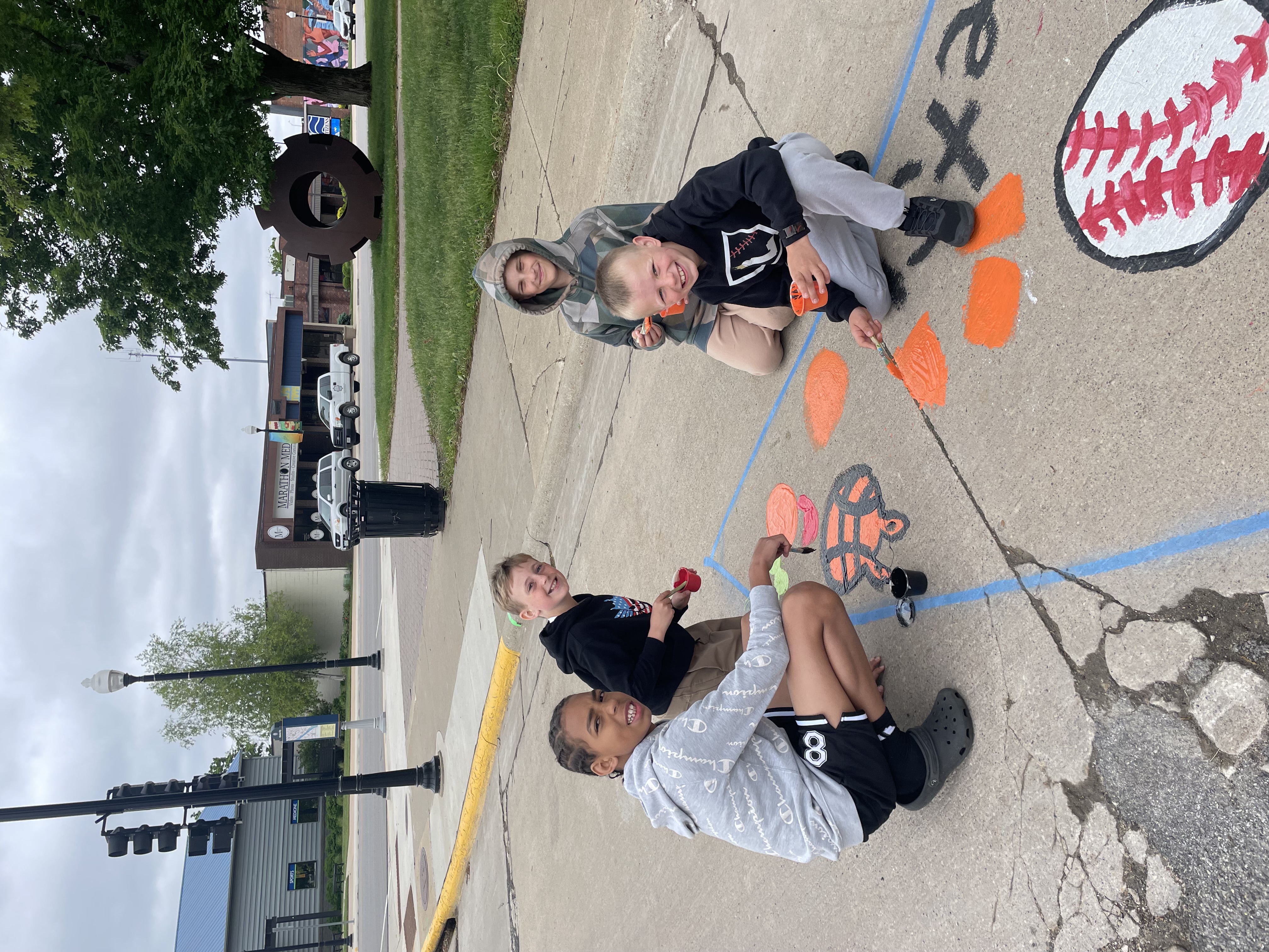 boys painting on road