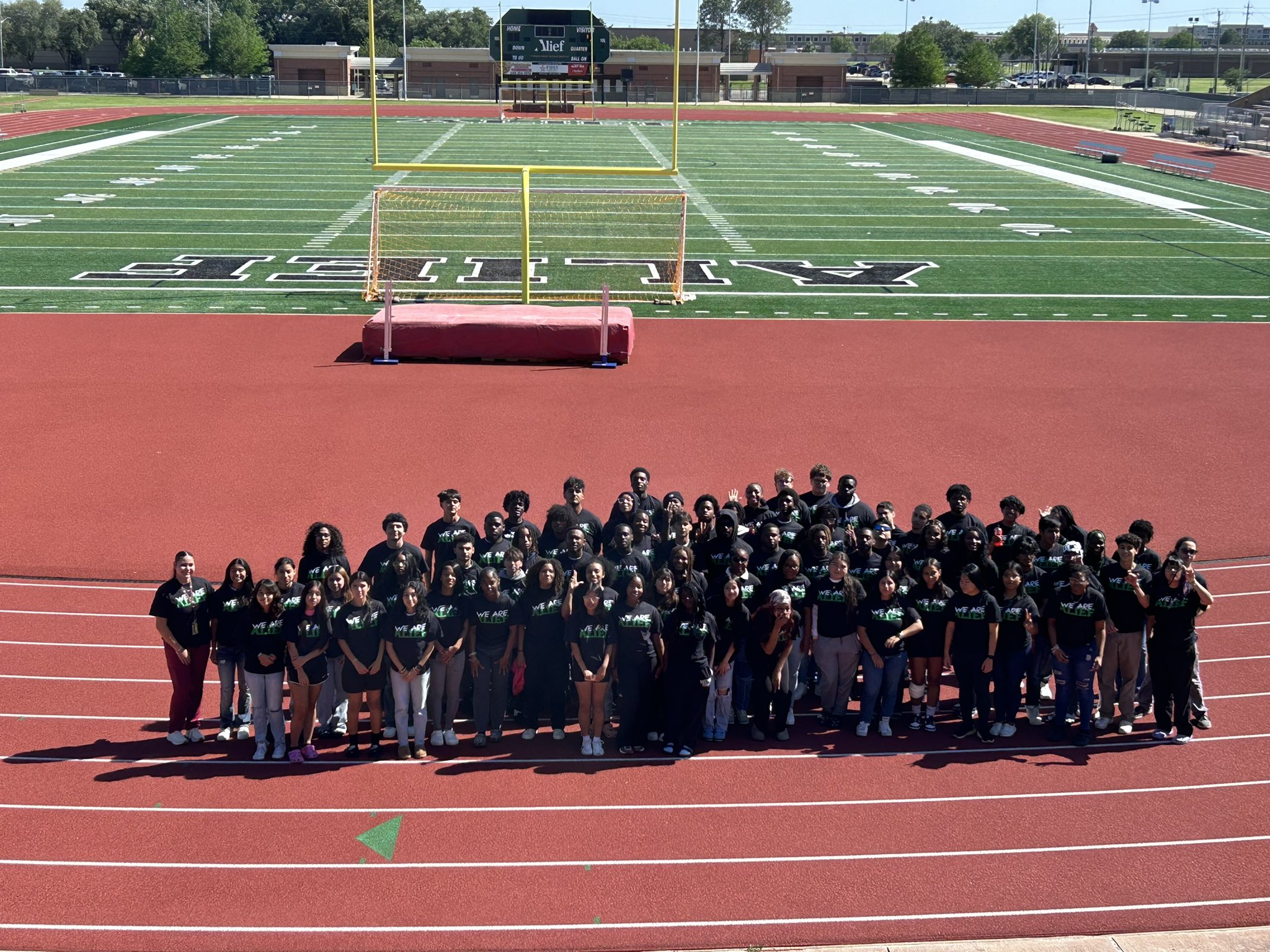 students pose on track