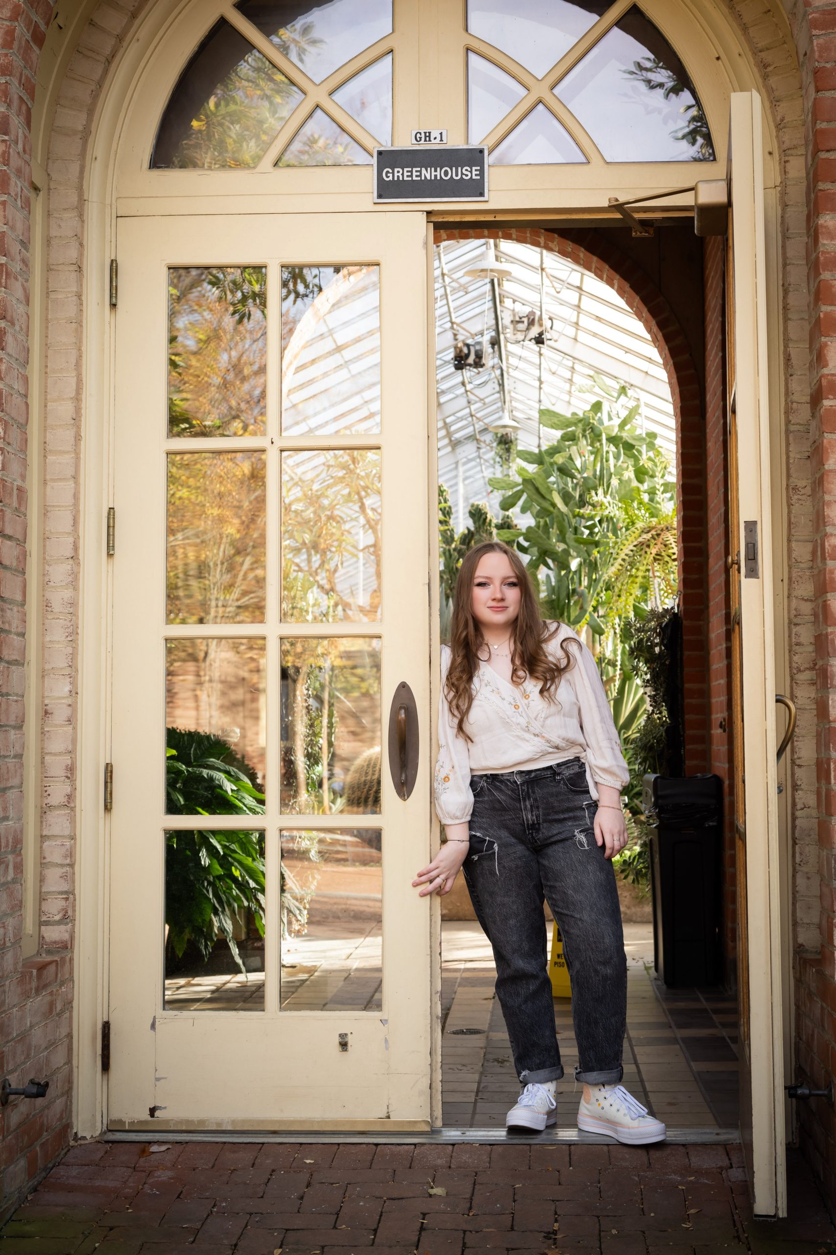 A woman standing in front of an open door, ready to embark on a new journey.