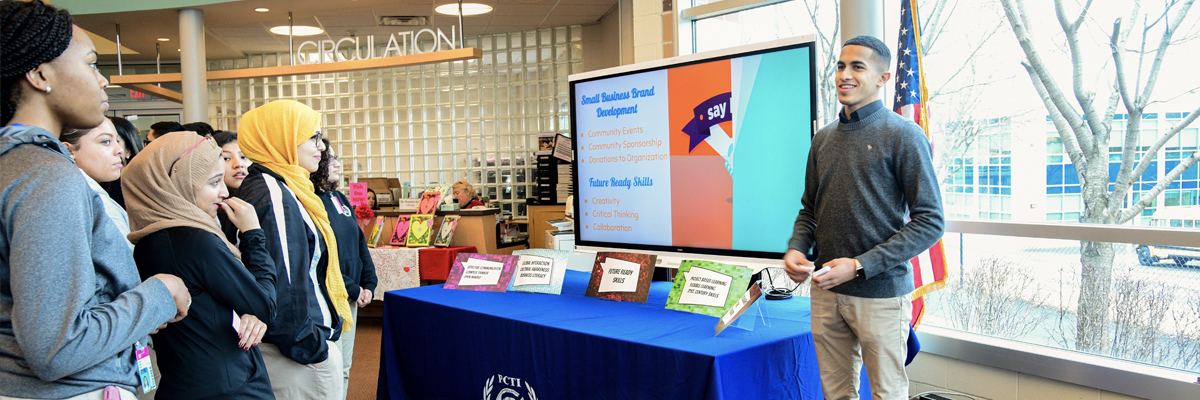 Students at a stand explaining