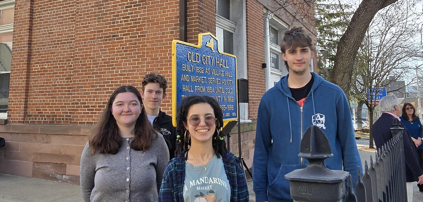 AHS students Rory Nowik, Ryan Stikkers, Heba Touijar, and Connor Riley at the old city hall historic marker unveiling
