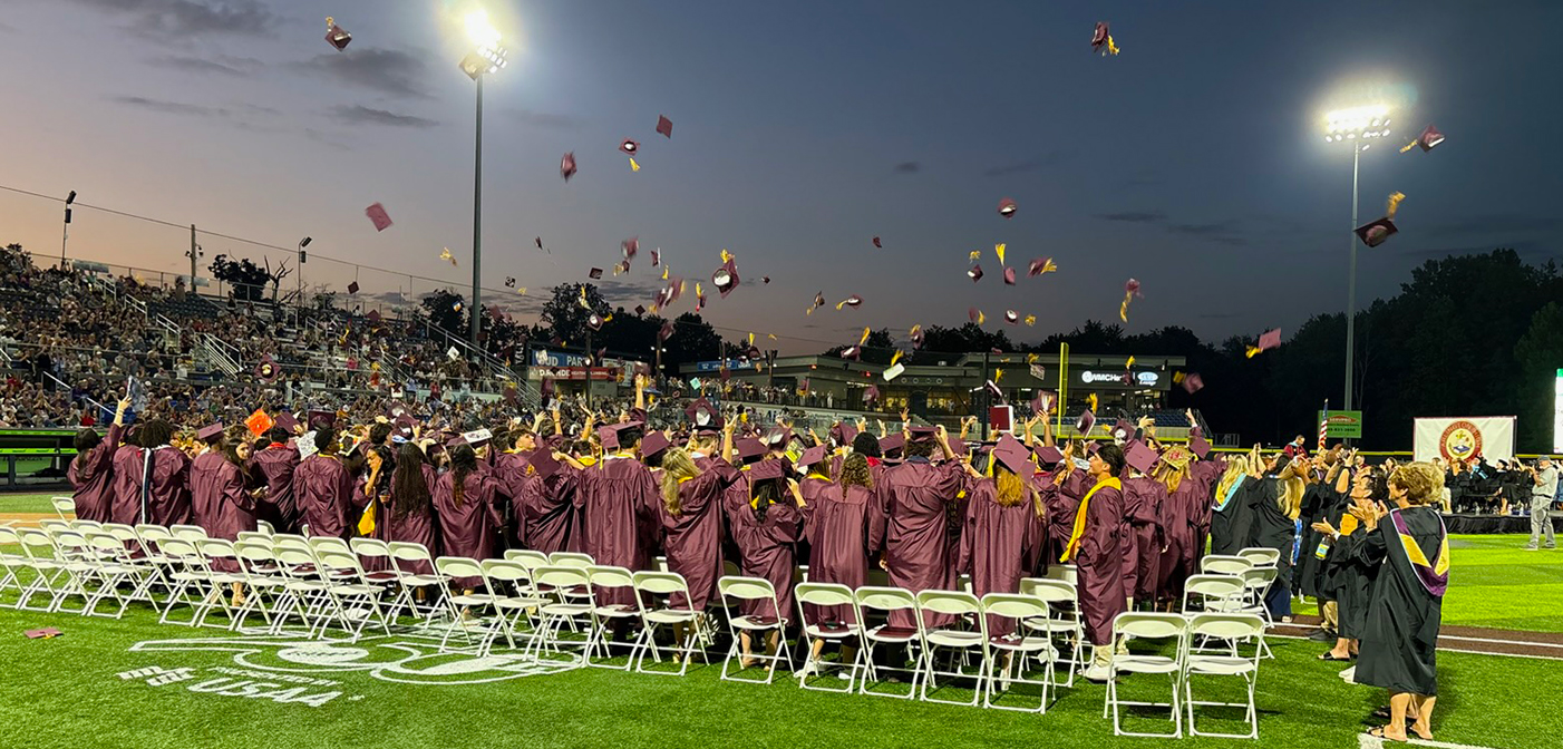 Arlington High School's graduates throw their caps in the air.