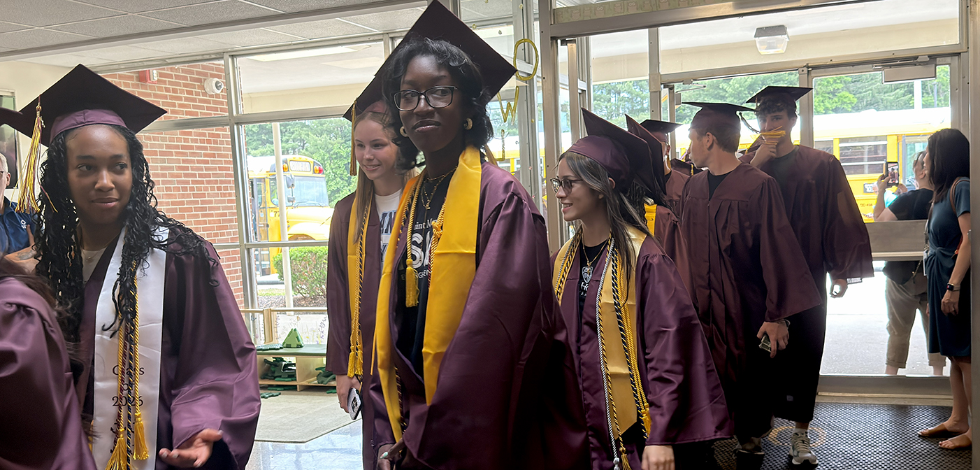 AHS seniors in caps and gowns entering Overlook school