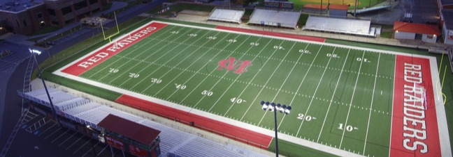 aerial view of football field with baseball field in background