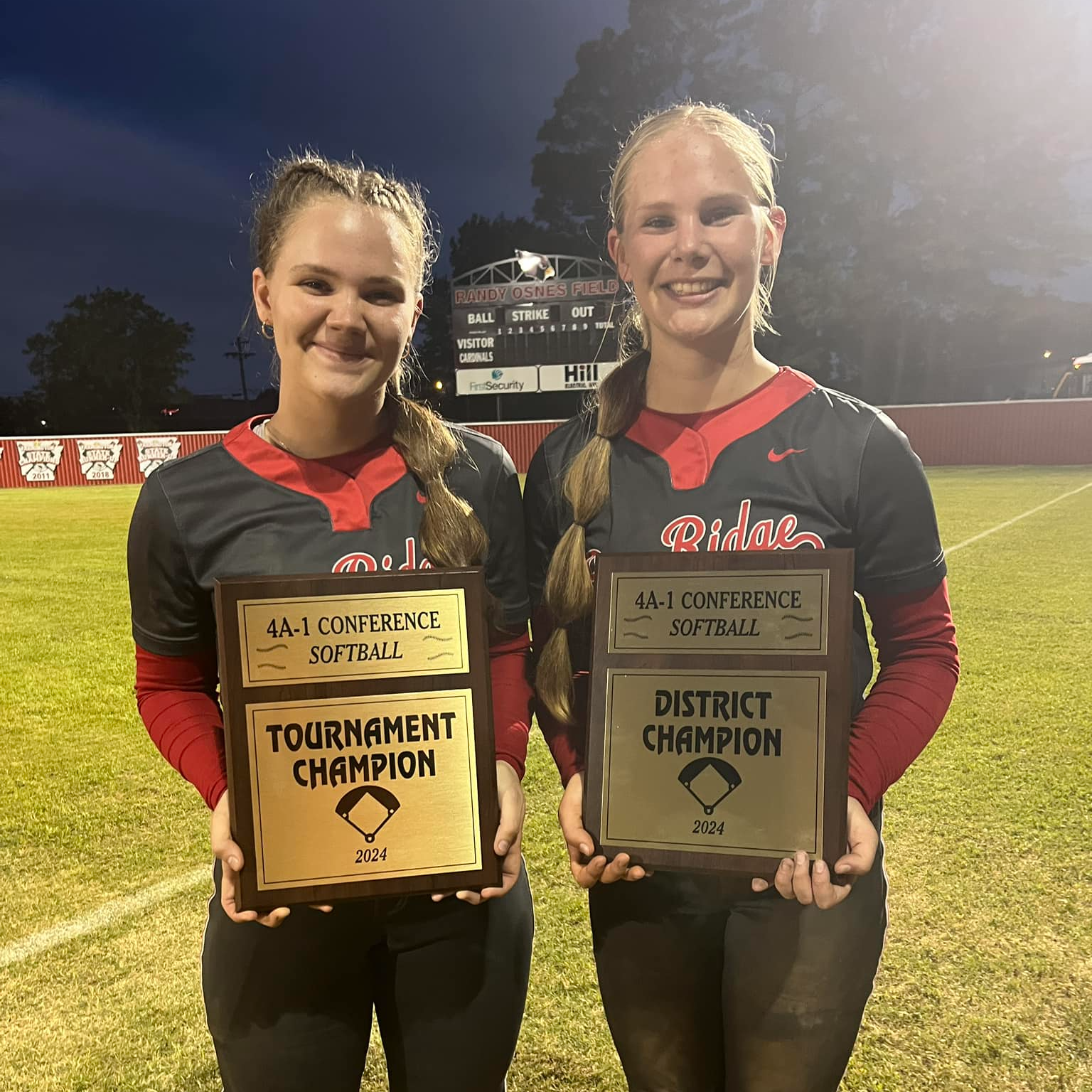 2 softball players w trophies