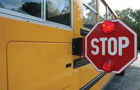 school bus with "stop" sign extended