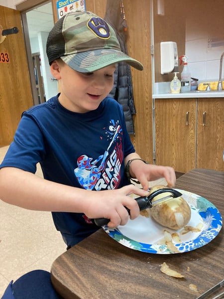 Child chopping on a table.