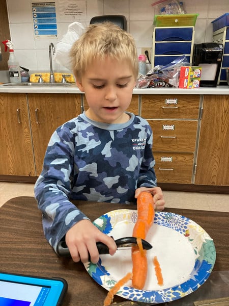 Child chopping on a table.