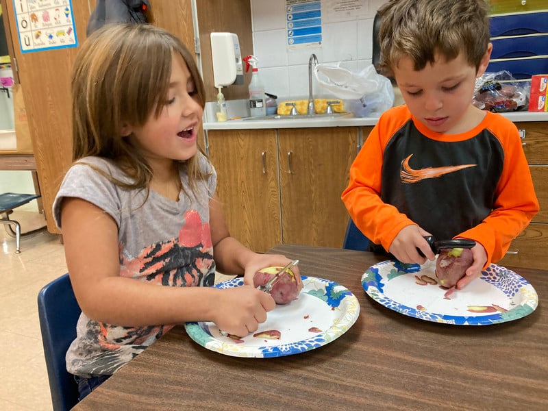 Child chopping on a table.