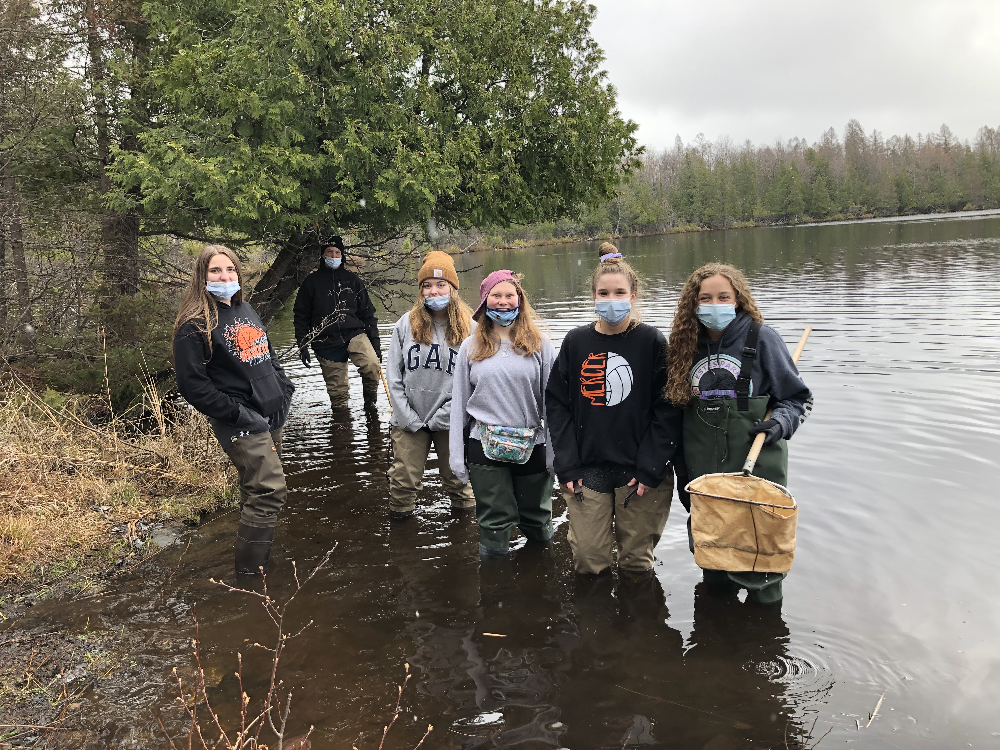 A group of people standing in a body of water