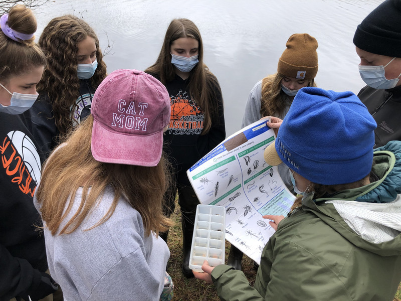 A group of young people standing around each other