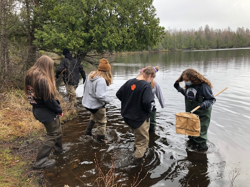 A group of people standing in a body of water