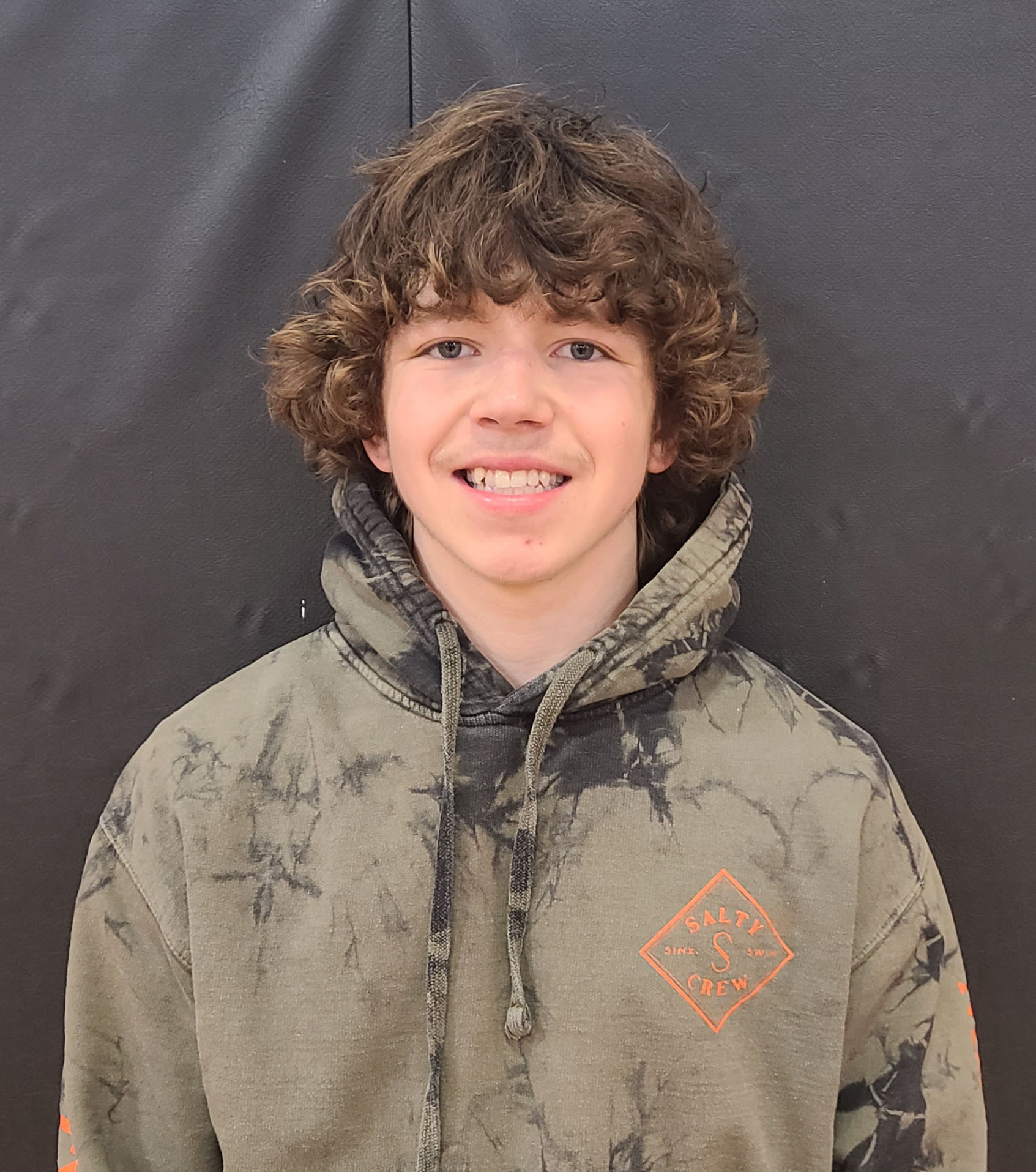 Image of a young boy wearing a camouflage hoodie.