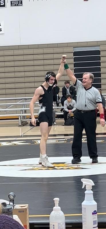 Image of a wrestler with arms raised in celebration