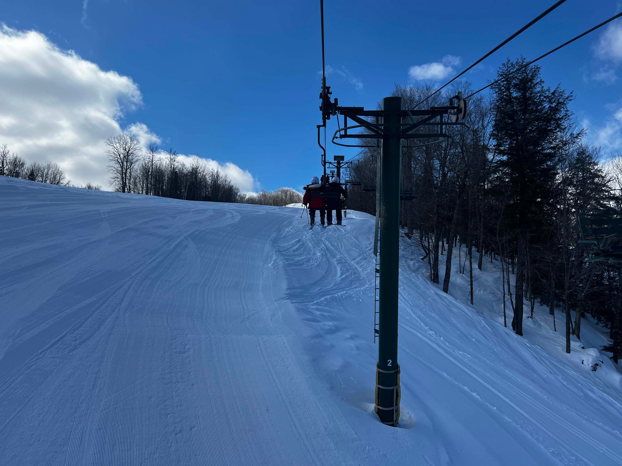 Two friends enjoying a ski lift ride