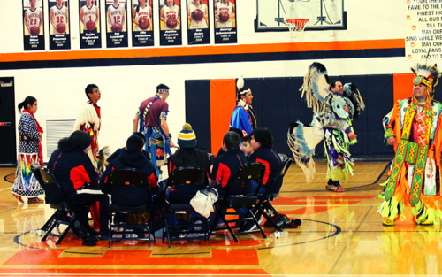 A group of people wearing Native American costumes at a cultural event.