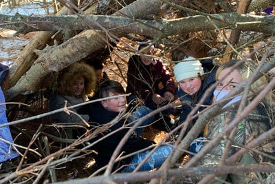 A group of people sitting in the woods