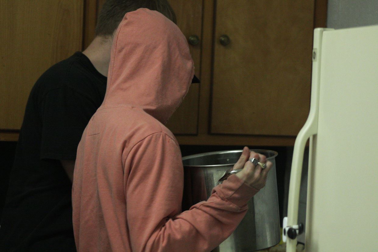 A student cooking in a kitchen