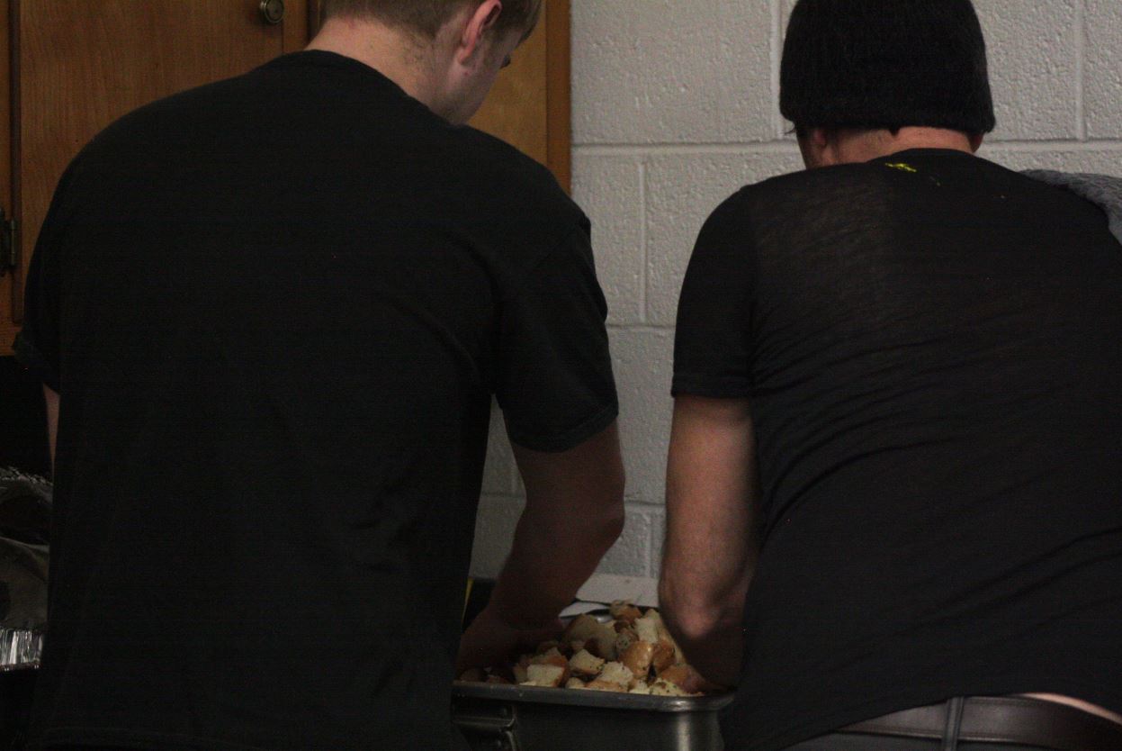 Two boys cooking in a kitchen