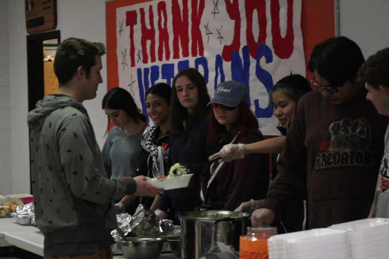 Group of students serving a food