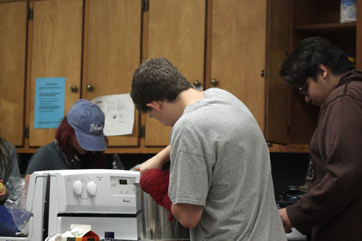 A boy cooking in a kitchen