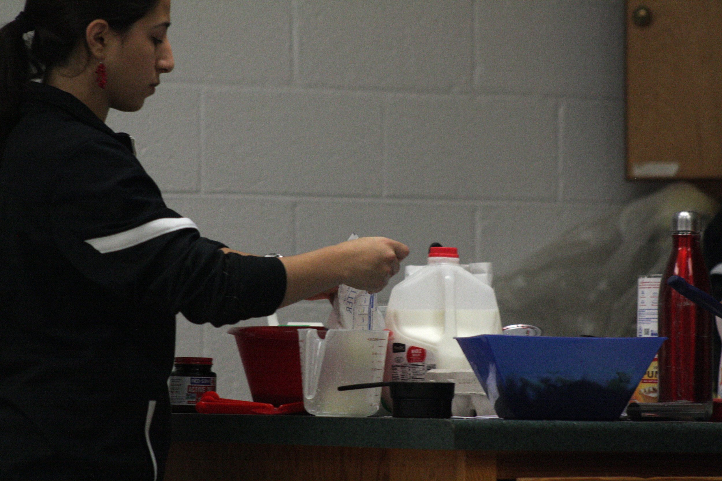 A woman cooking in a kitchen