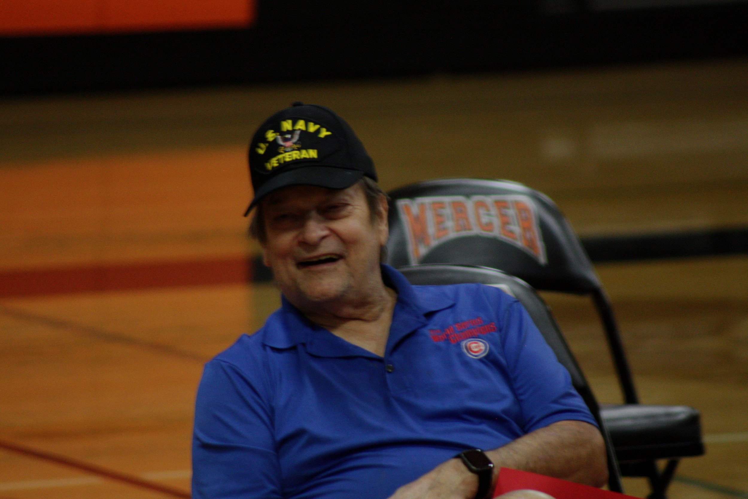 A man sitting in a chair on a basketball court