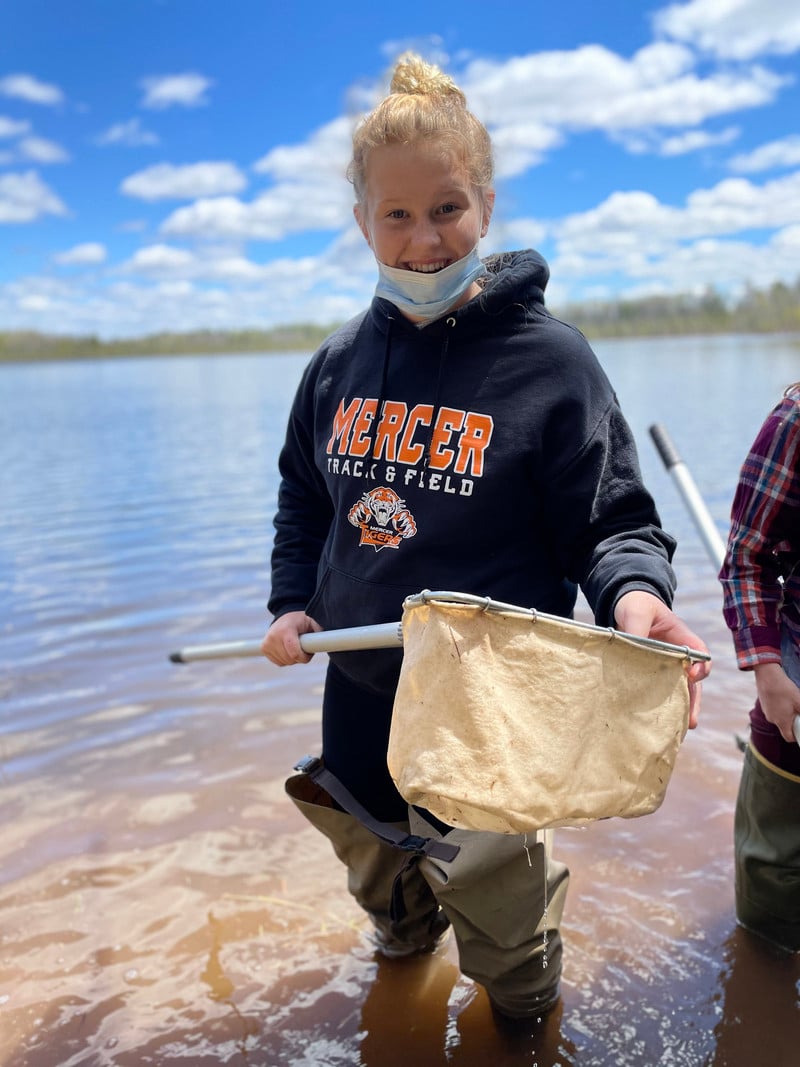 A girl holding a net in the water