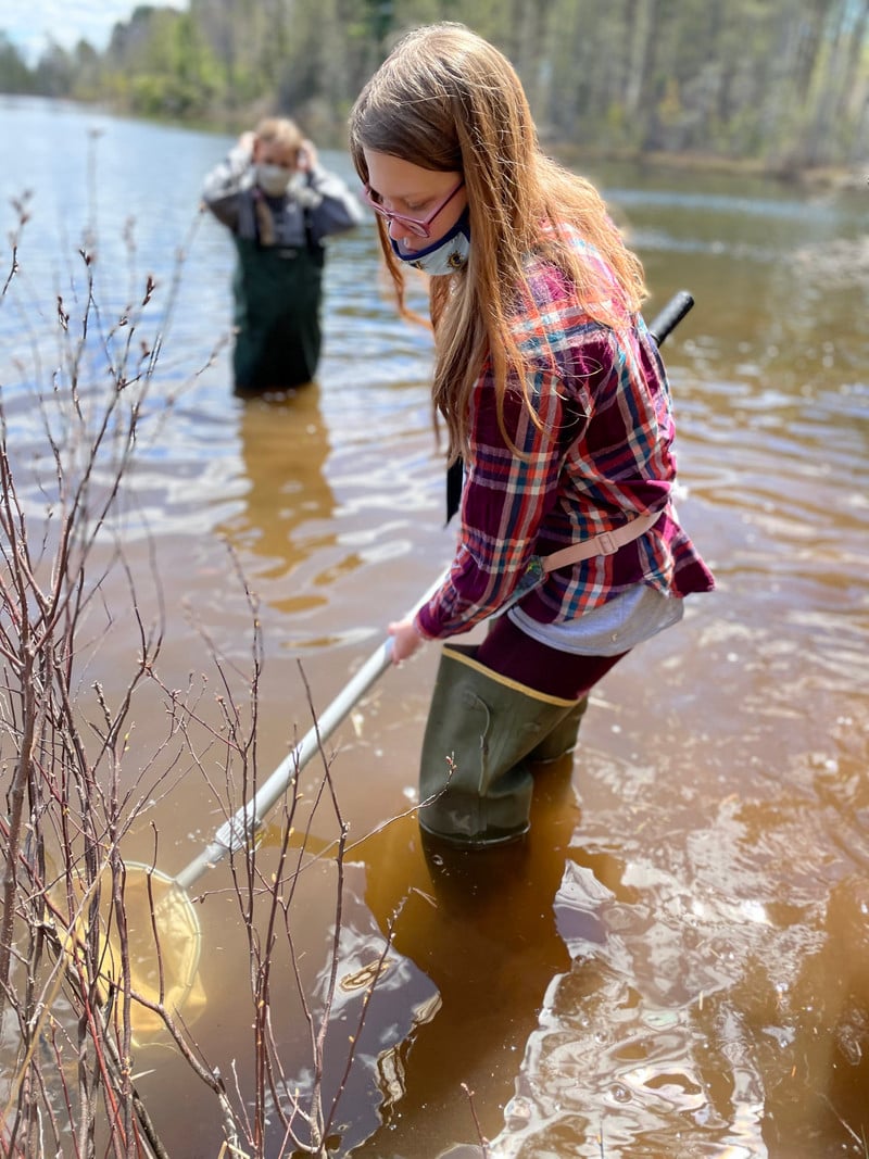 A girl holding a net in the water