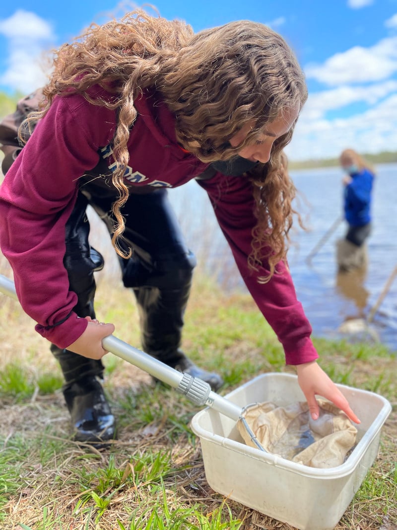 A girl holding a net in the water