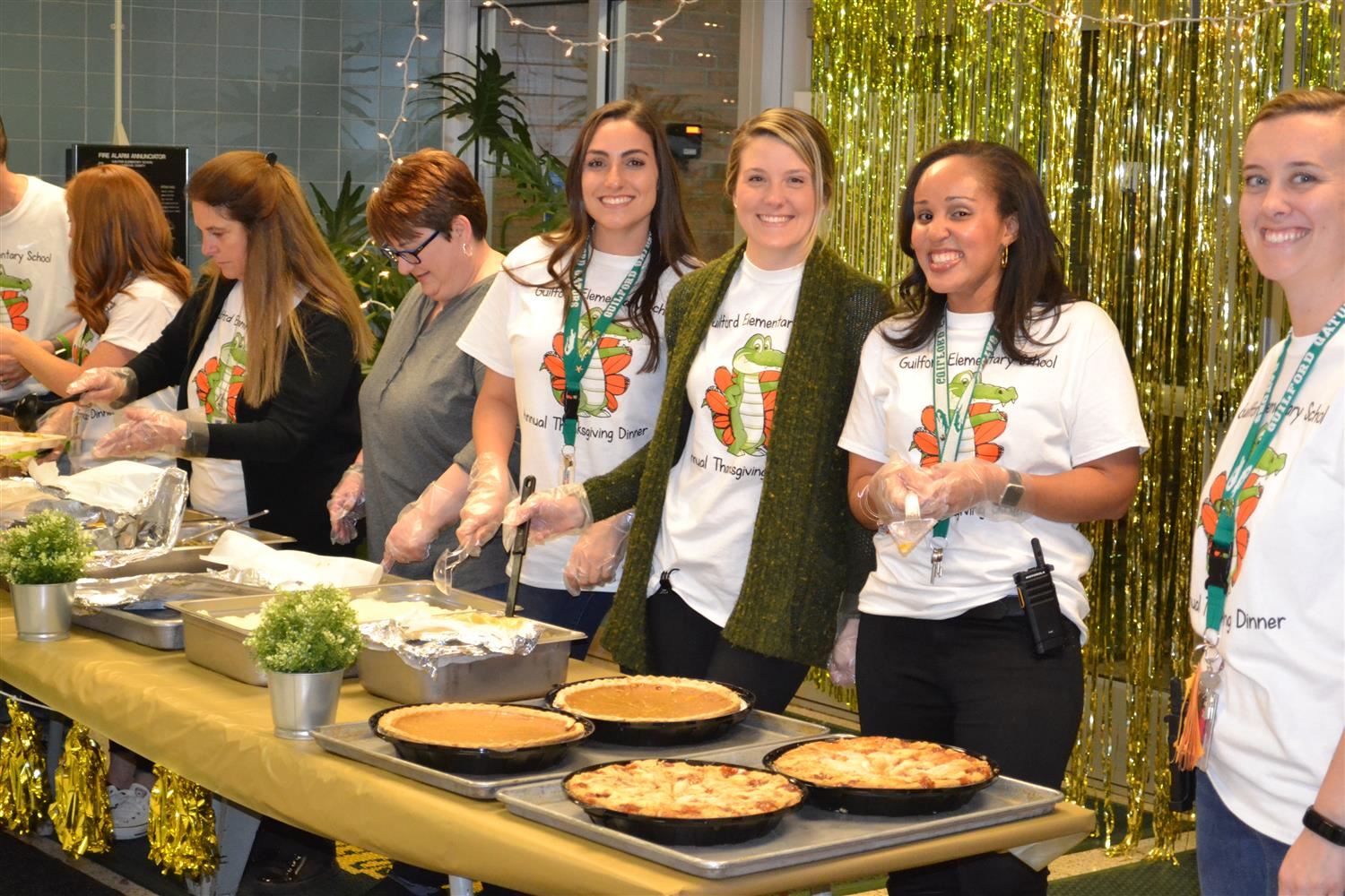 A group of students smiling and volunteering 