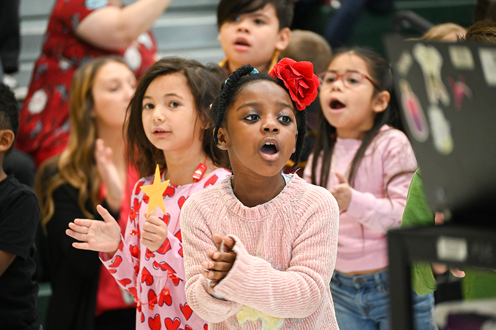 Students singing and clapping