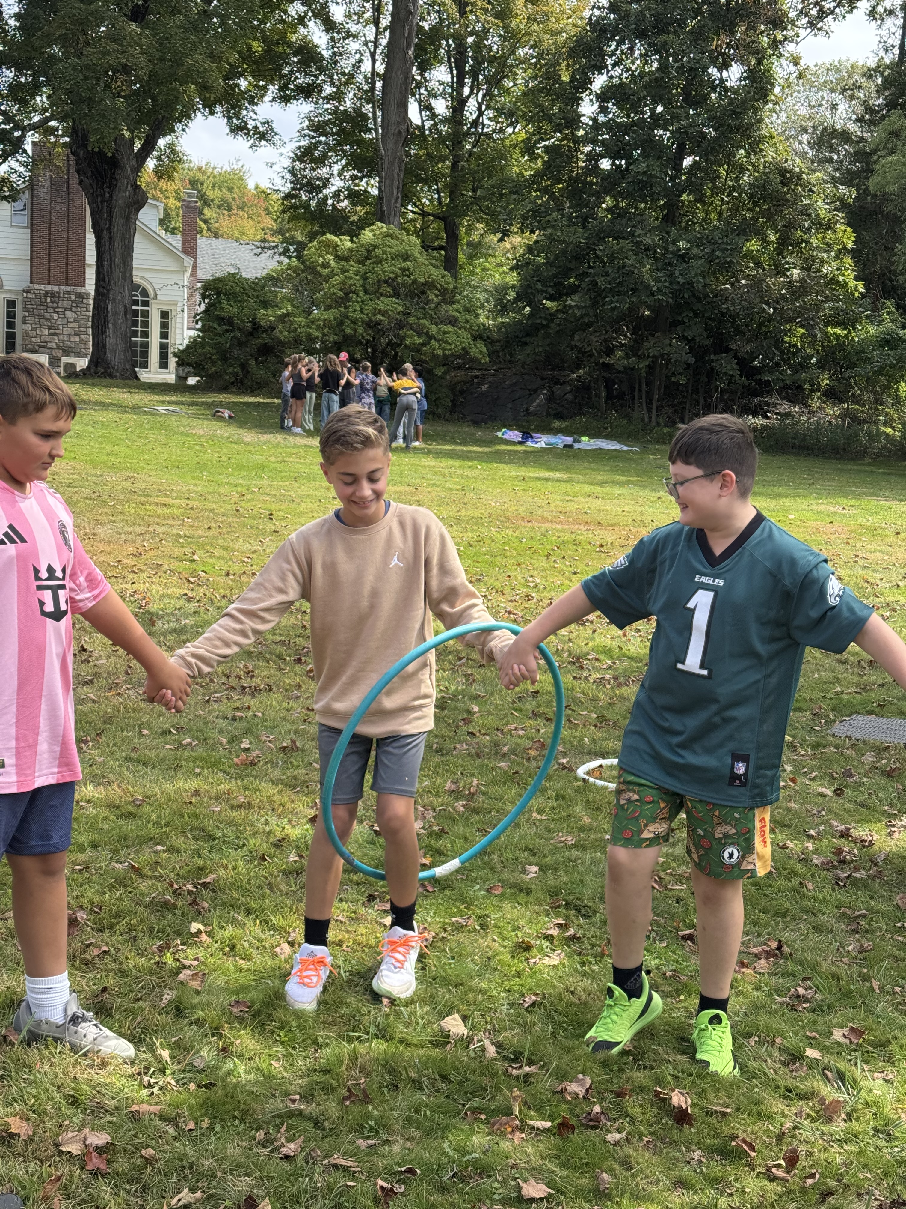 Pictures of students working together in the woods on obstacles