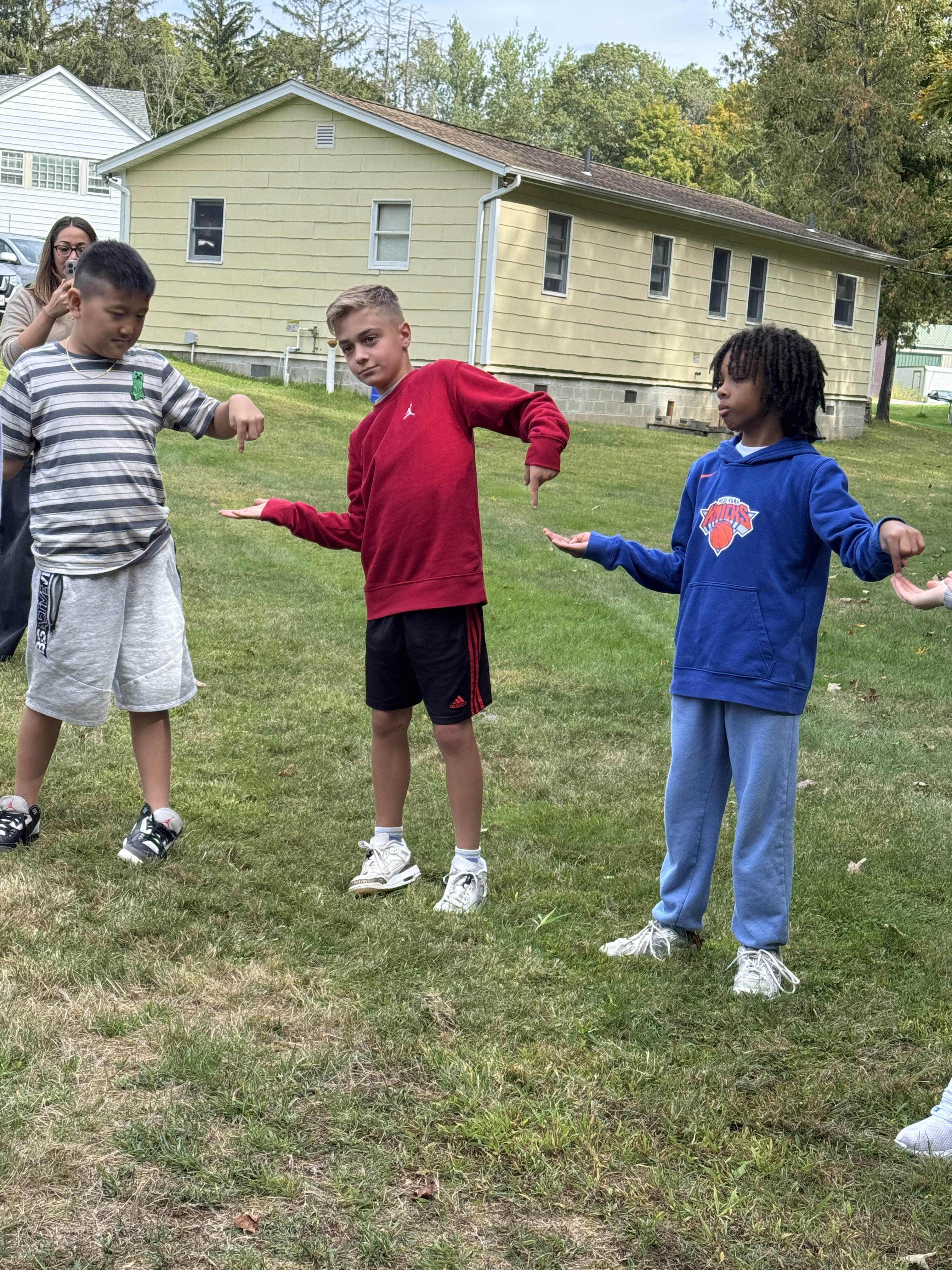 Pictures of students working together in the woods on obstacles
