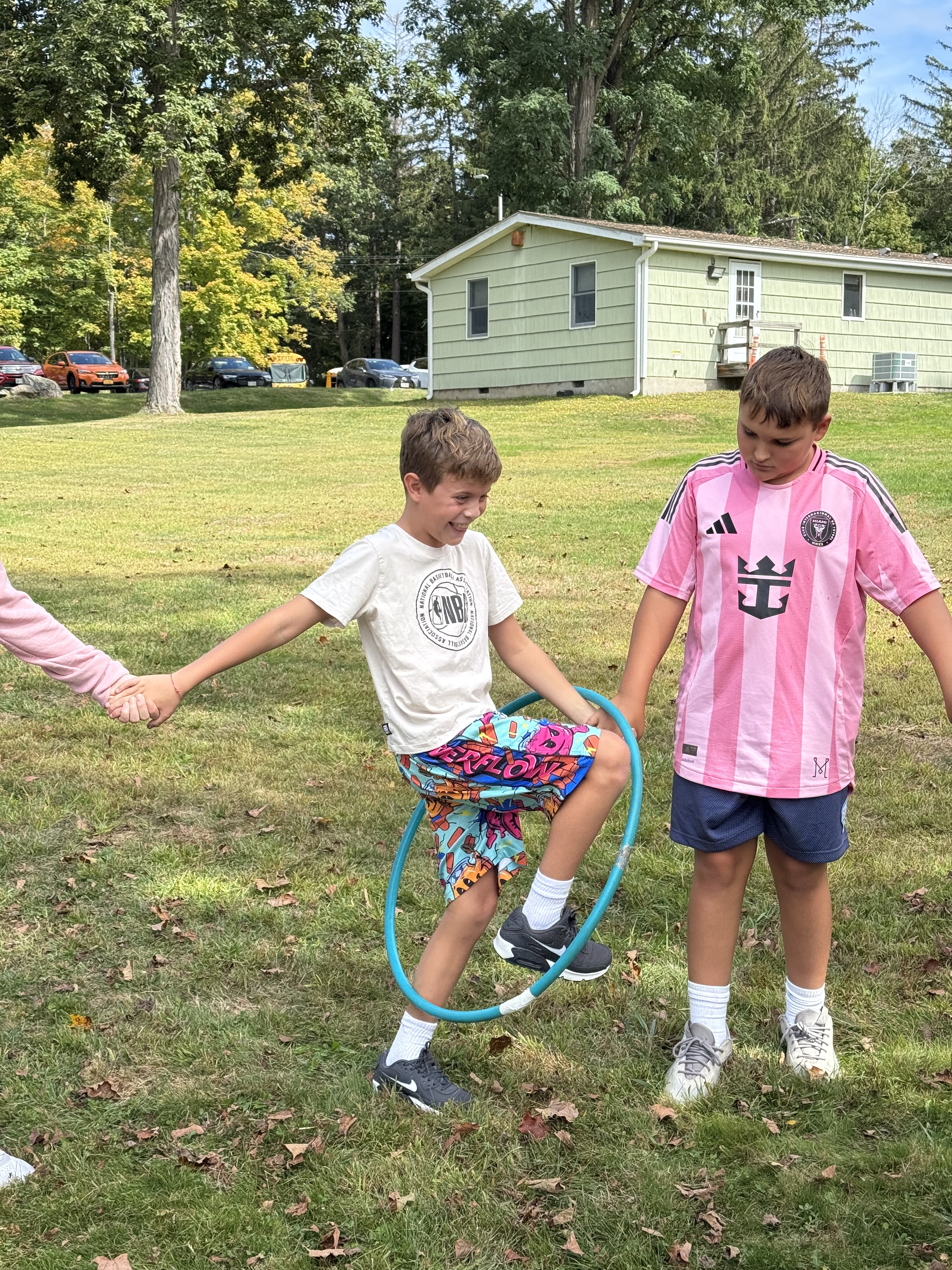 Pictures of students working together in the woods on obstacles