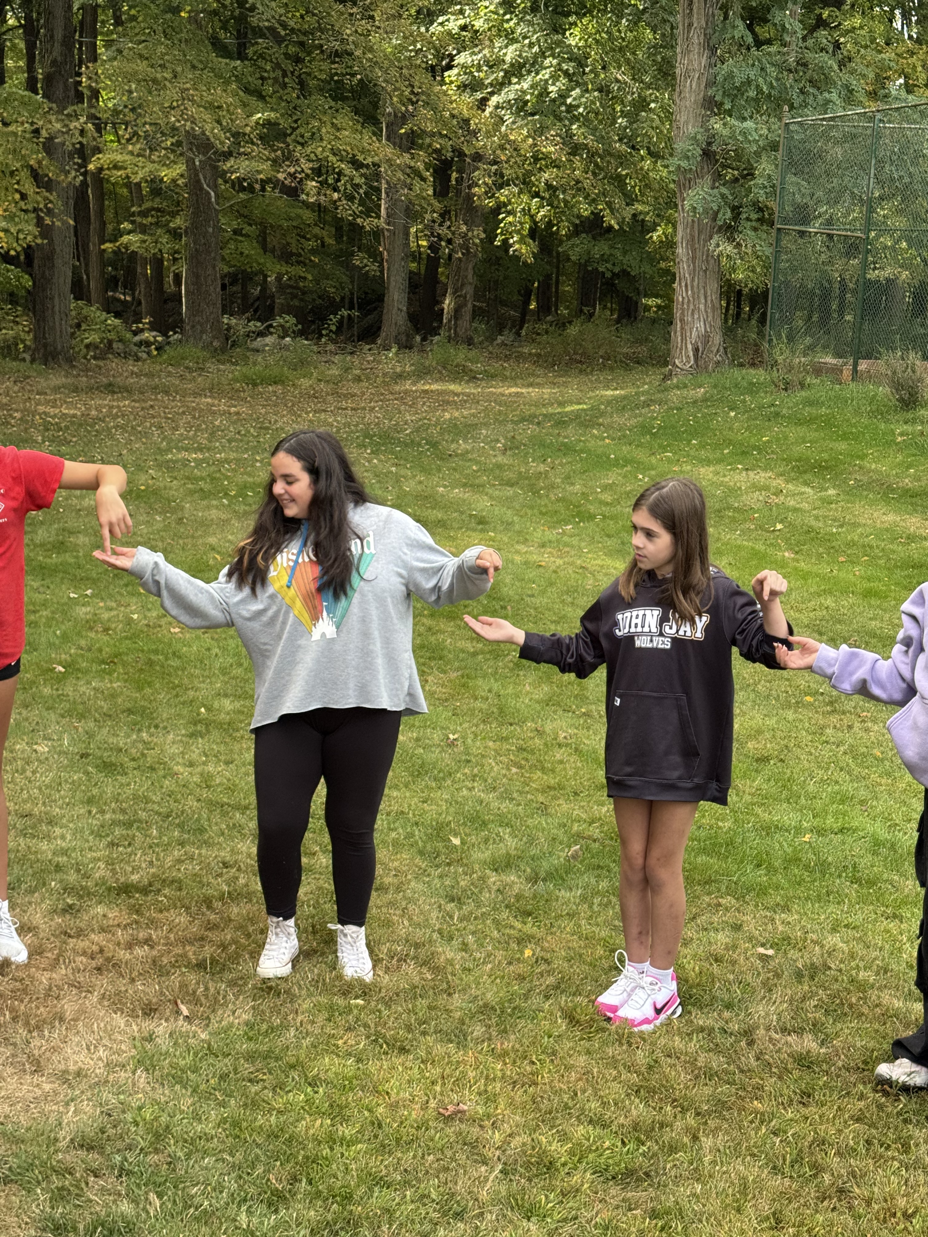 Pictures of students working together in the woods on obstacles