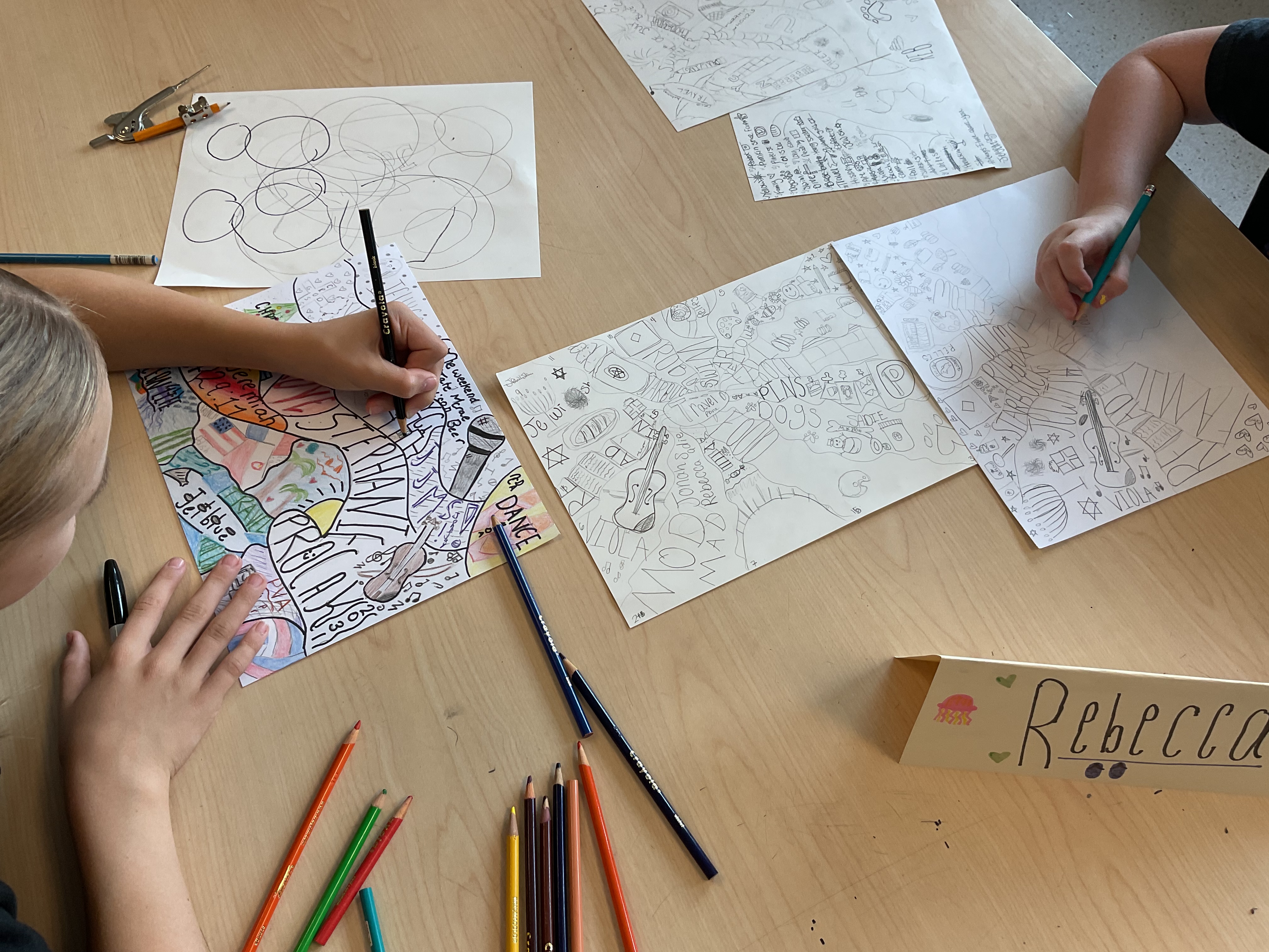 Students in 7th grade art class are working on an "All About Me Illustrated Map" where they explore their passions, values, identity and culture using various drawing techniques and materials.