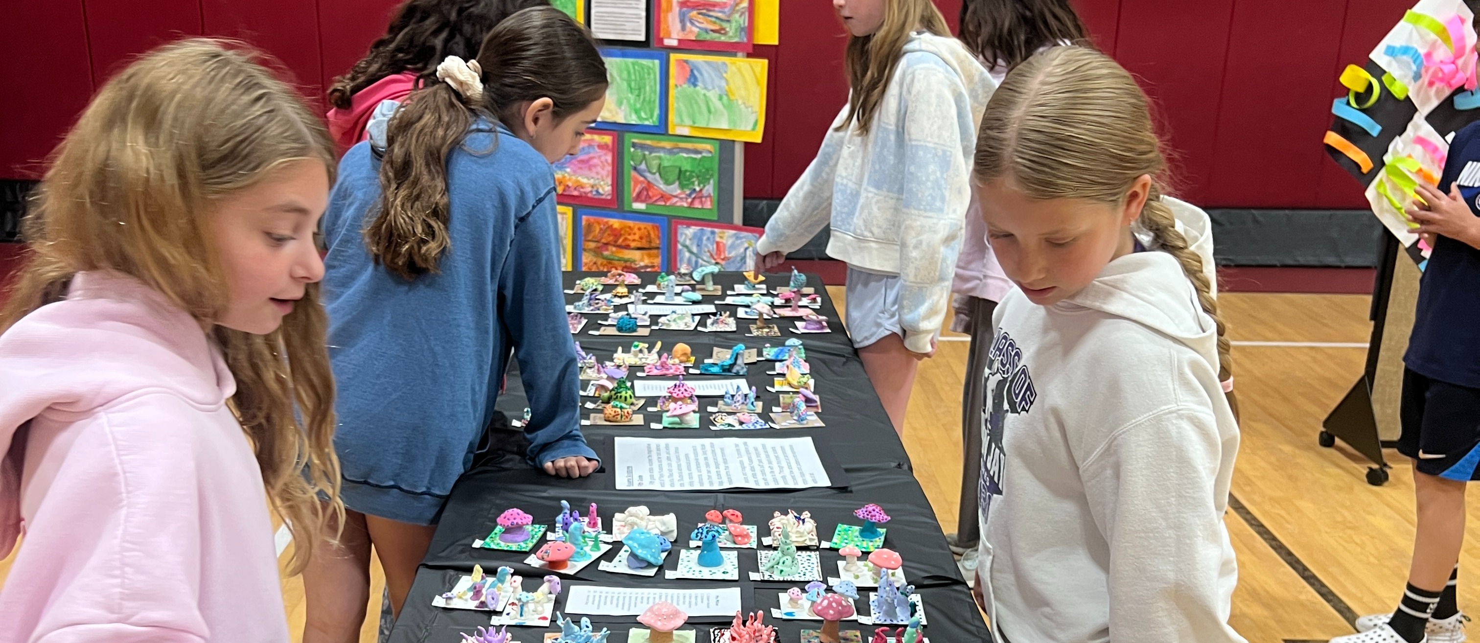 students standing with artwork
