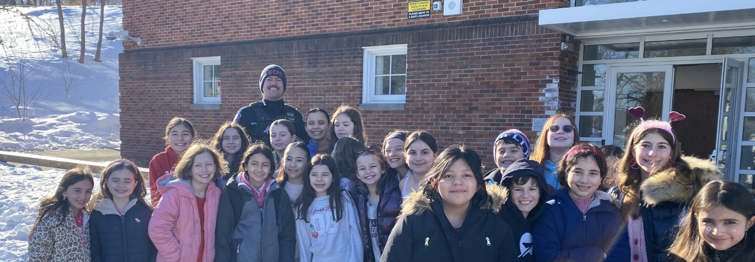 students gather outside with SRO officer 