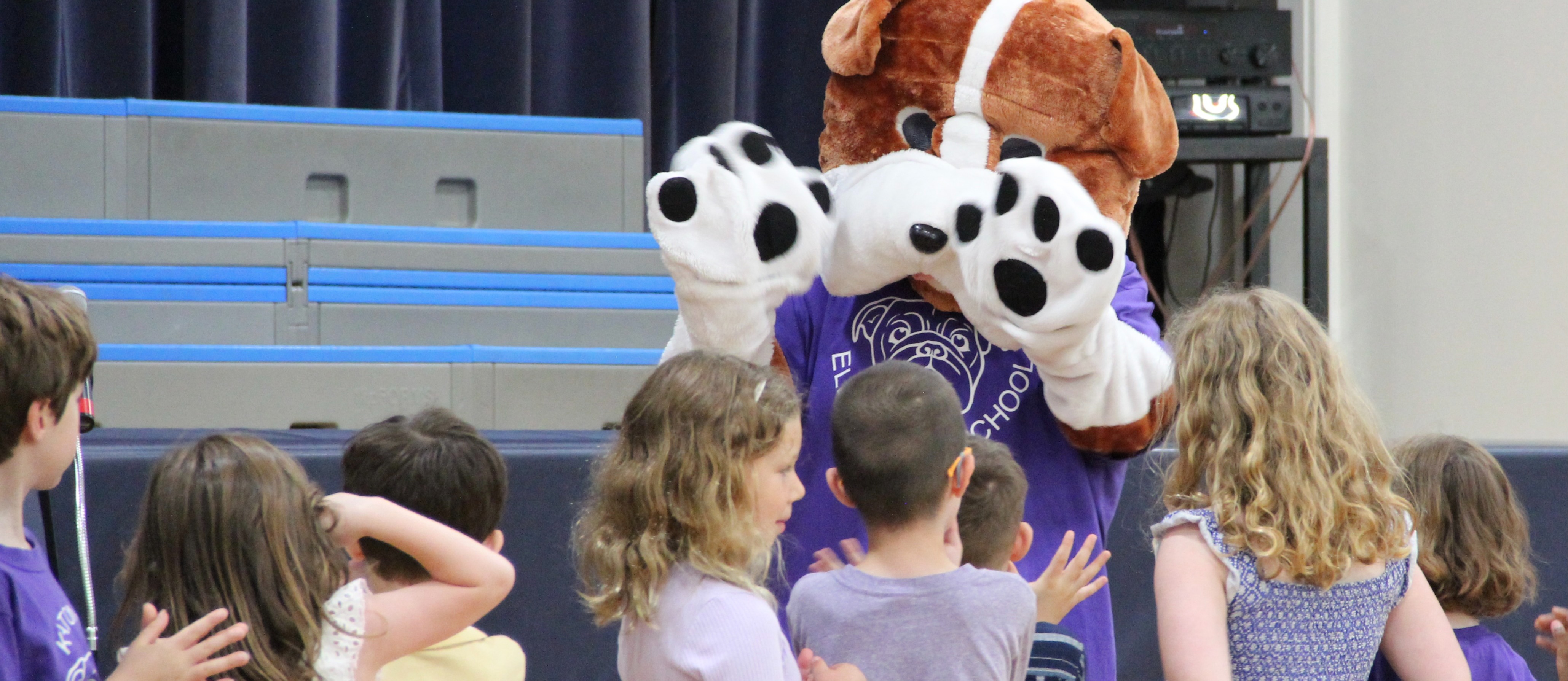 students standing with mascot