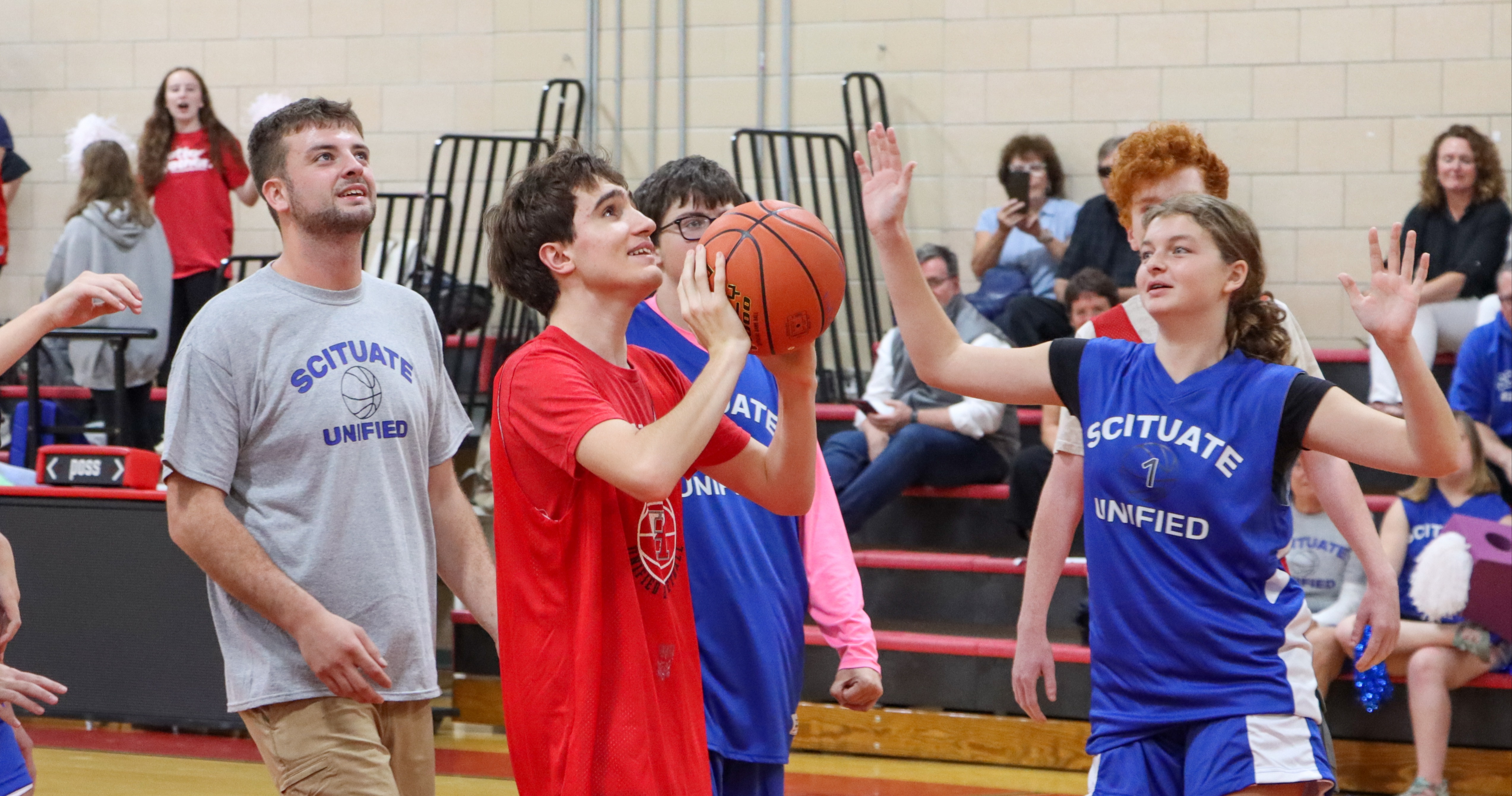 student going to shoot a basket at the unified baskeball game vs. situate.