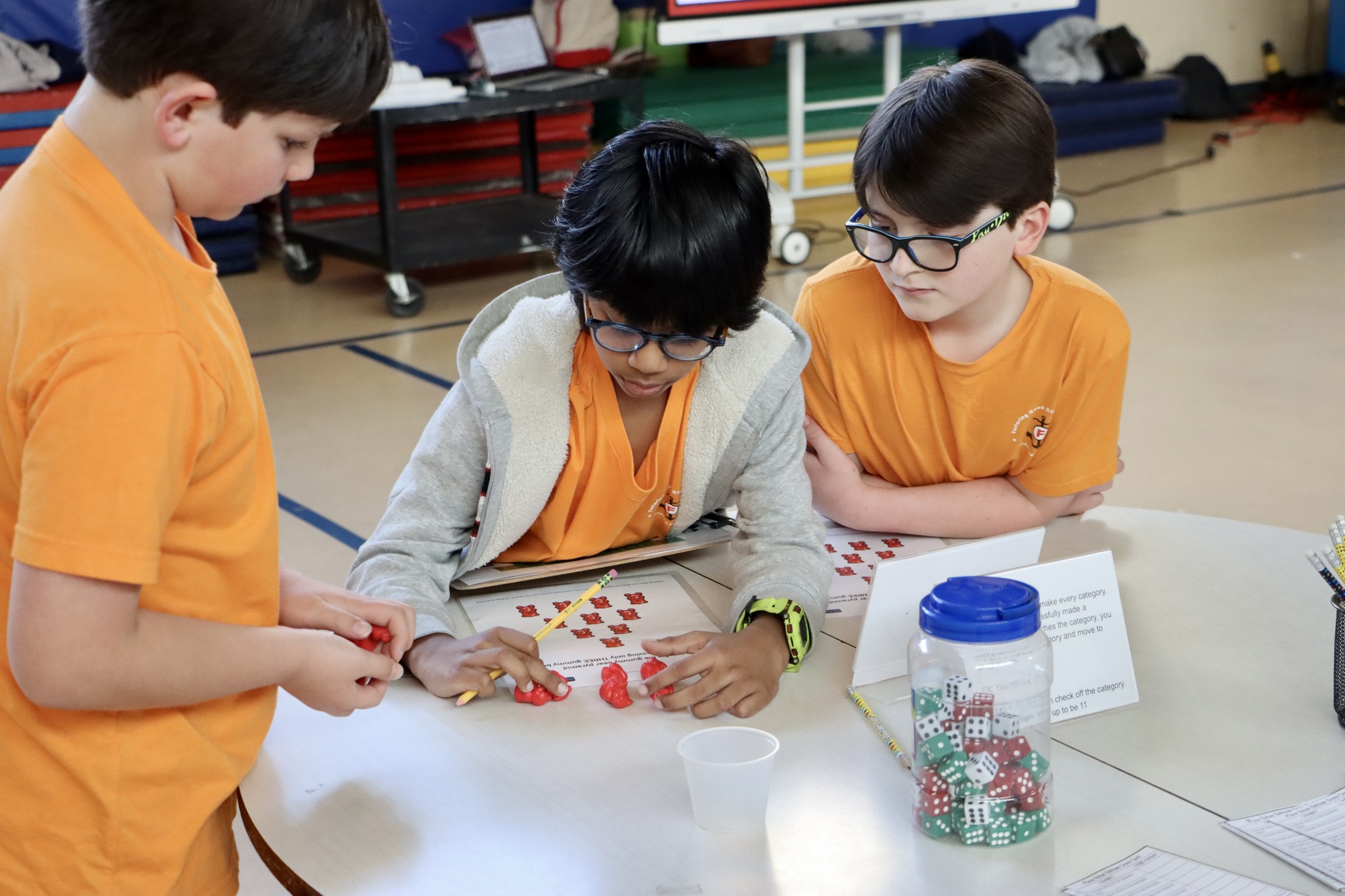 3 kids doing a math puzzle.