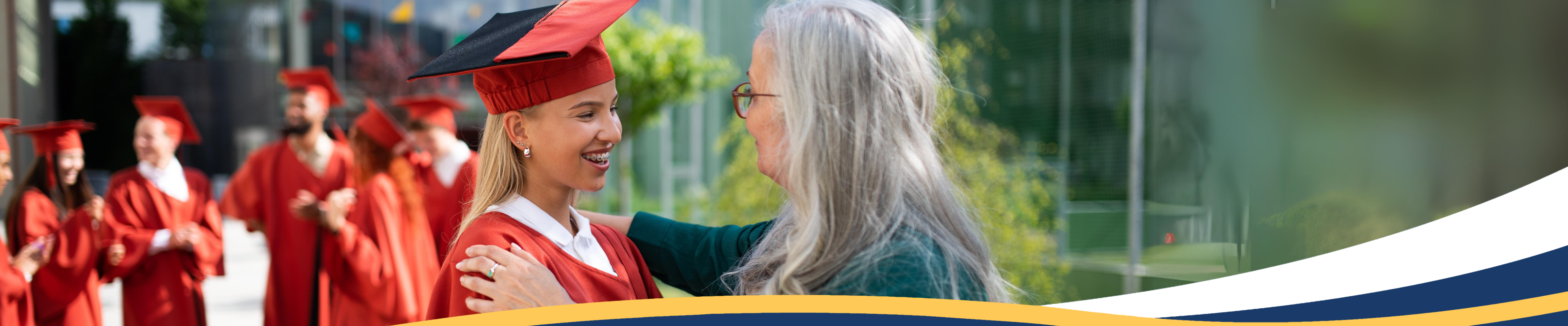 Grandmother patting shoulder of granddaughter at graduation