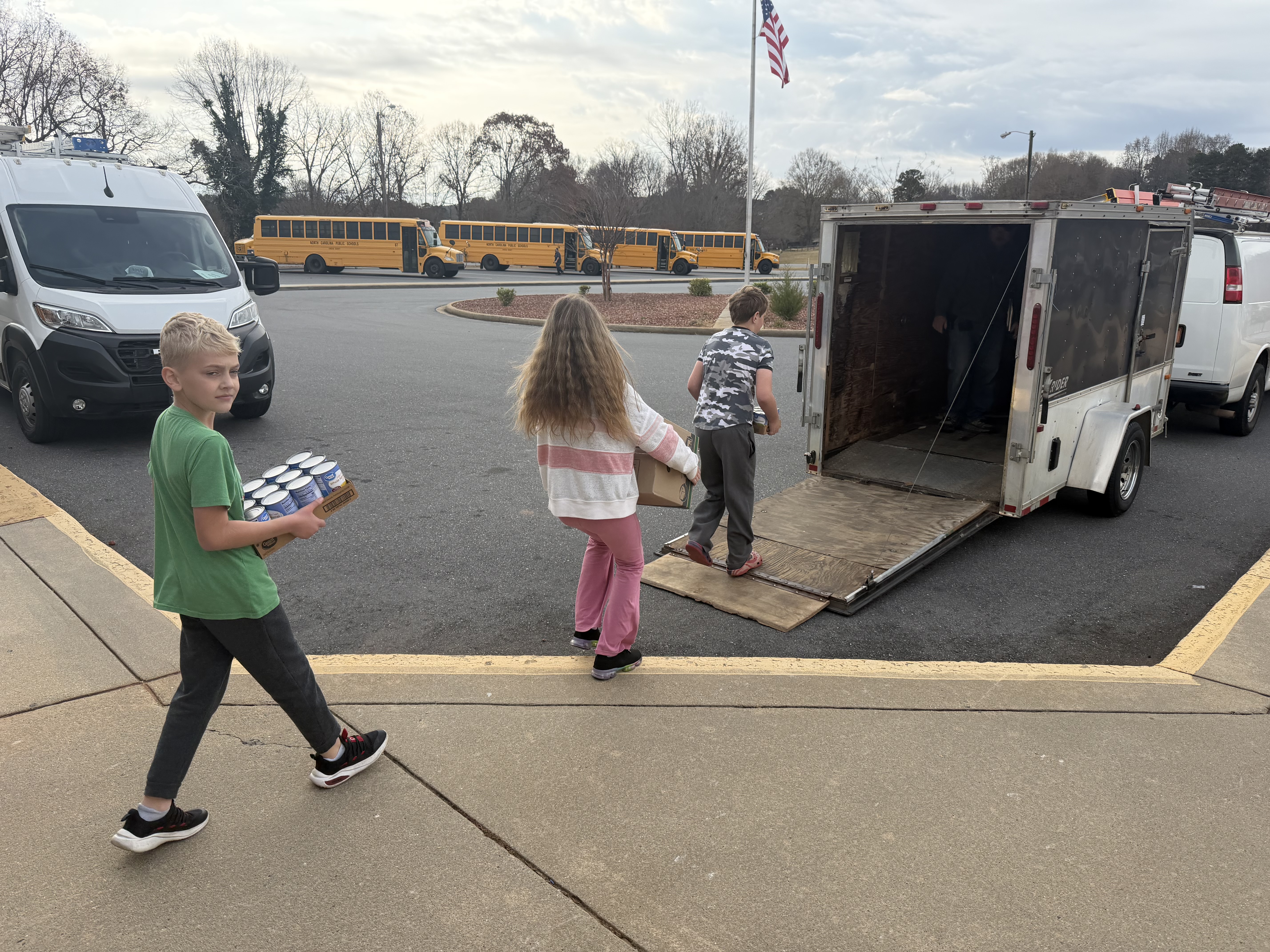 Students load items from our can food drive.  