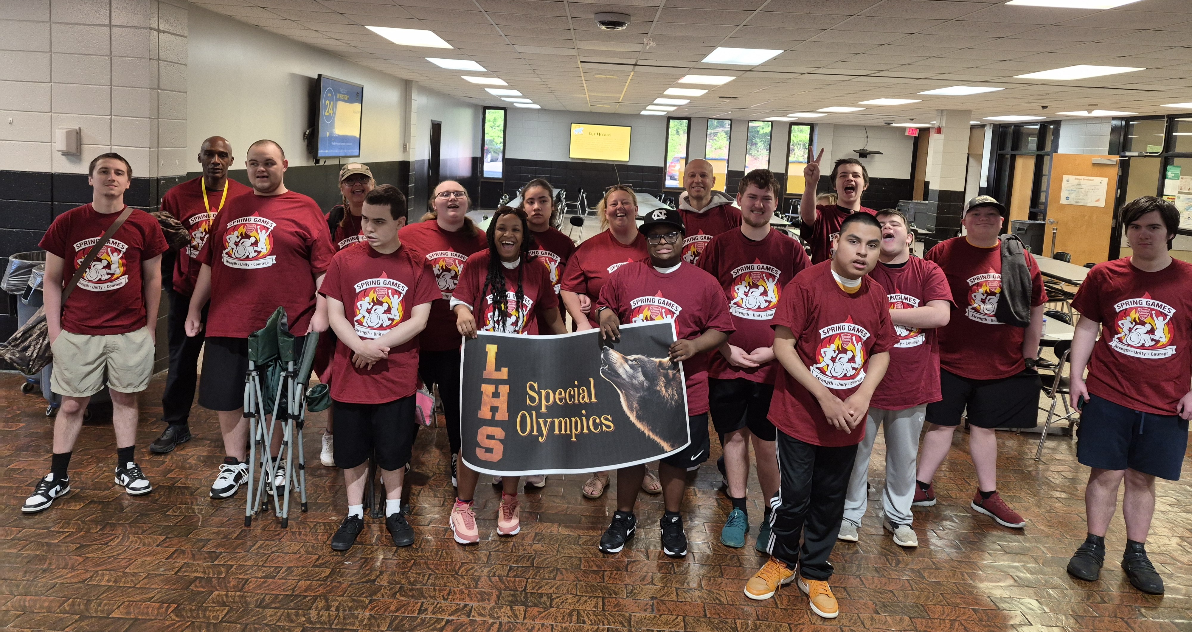 Lincolnton High Special Olympics Athletes stand together with a banner that reads LHS Special Olympics.