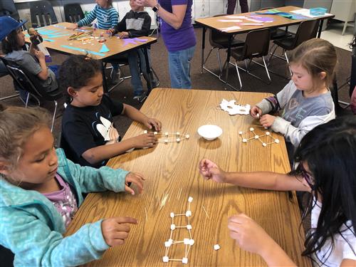 students work on craft project at table